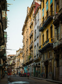 Street amidst buildings in city against sky