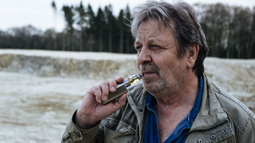 Portrait of man smoking cigarette