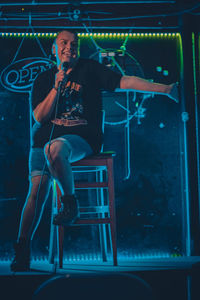 Full length of young man sitting on chair