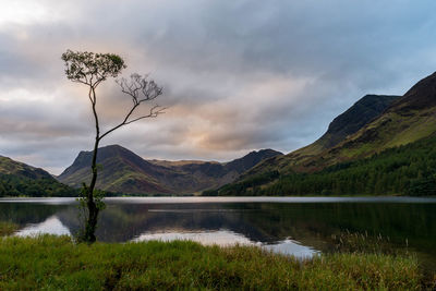 Scenic view of lake and mountains against sky