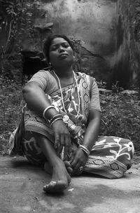 Portrait of woman wearing sari while sitting on field