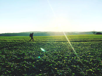 Woman standing on field against sky
