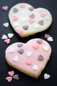 High angle view of heart shape cookies on black background