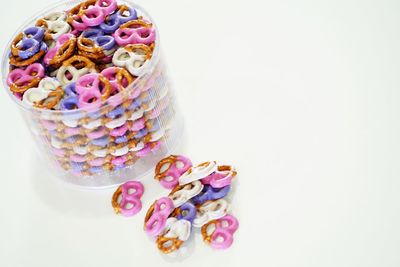 Close-up of multi colored candies against white background