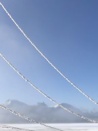 Low angle view of vapor trail against clear blue sky