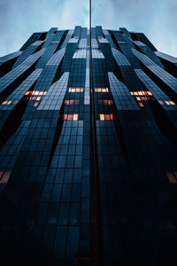 Low angle view of modern building against sky at night