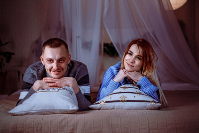 Friends relaxing on bed