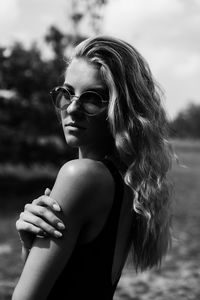 Portrait of young woman looking away outdoors