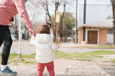 Mother and daughter walking outdoors