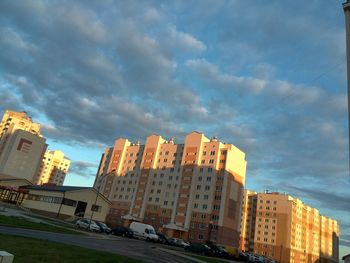 Buildings against cloudy sky