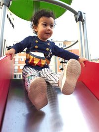 Portrait of cute boy sitting outdoors