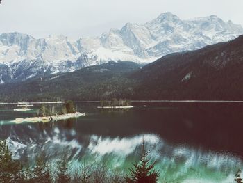 Scenic view of lake and mountains against sky