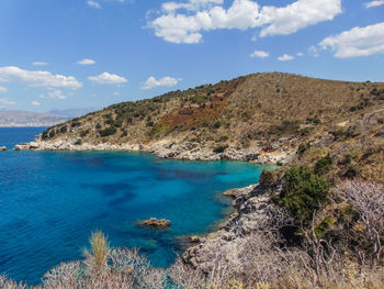 Scenic view of sea and mountains against sky