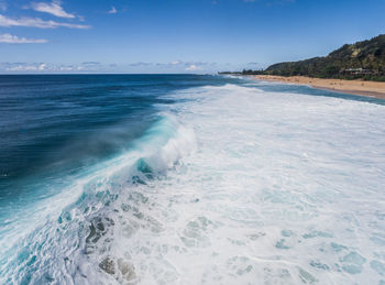 Scenic view of sea against blue sky