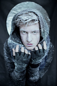 Close-up portrait of young woman in snow