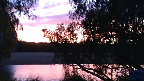 Scenic view of lake against sky at sunset