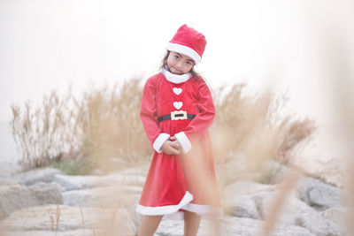 Full length portrait of cute girl wearing red hat