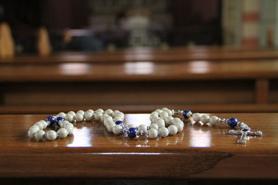 Close-up of rosary on table