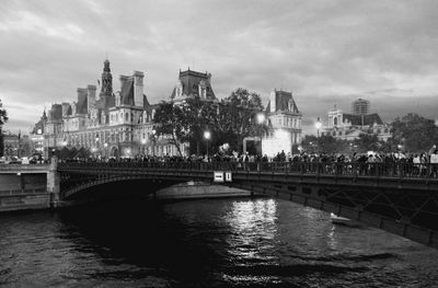 View of bridge over river against cloudy sky