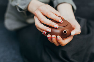 Midsection of woman holding herbal tea 