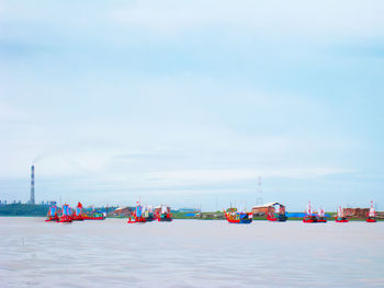 Boats on beach against sky