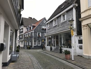 Street amidst buildings against sky