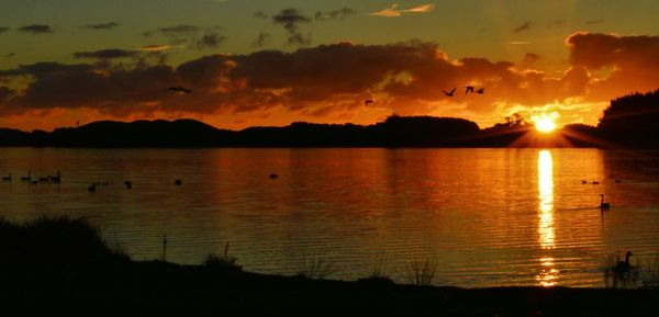 Scenic view of sunset over lake