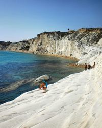 High angle view of woman sitting at scala dei turchi