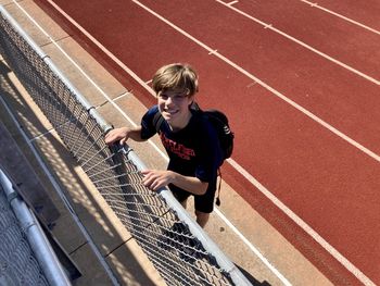 Portrait of young boy at track and field event 