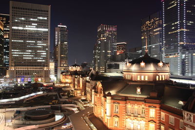 Illuminated cityscape against sky at night