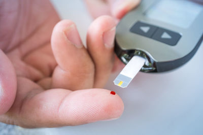 Close-up of hand holding camera
