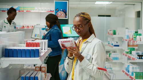 Portrait of female doctor examining chemical in laboratory