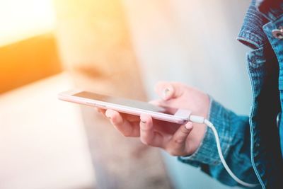 Midsection of man using mobile phone