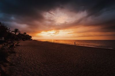 View of calm beach at sunset