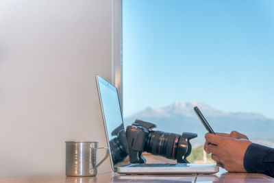 Cropped hand of man working on table