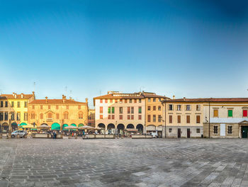 Buildings in city against blue sky