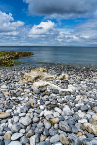 Rocks on beach against sky