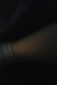 Defocused image of woman against black background