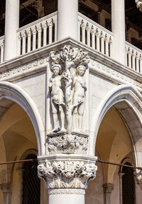 Low angle view of statue against historic building