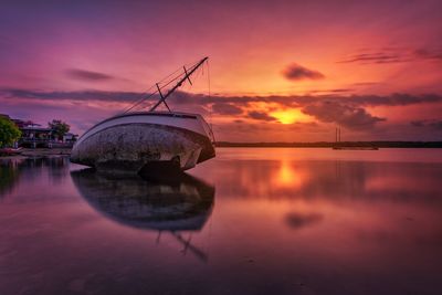 Scenic view of lake against orange sky