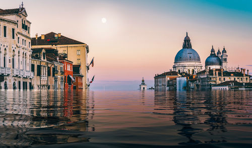 Reflection of building in water at sunset