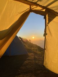 Tent against sky during sunrise
