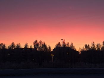 Silhouette trees against sky during sunset