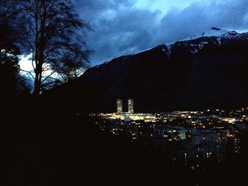 Aerial view of illuminated cityscape against sky at night