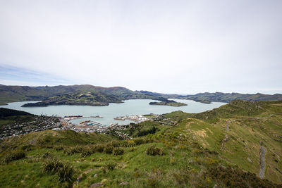 Scenic view of sea and mountains against sky