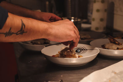 Midsection of man preparing food on table