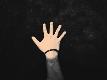 Close-up of hand against black background