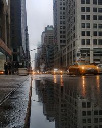 Reflection of buildings in puddle