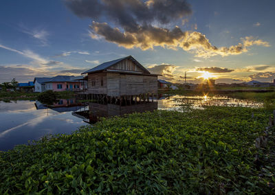 Scenic view of building against sky during sunset