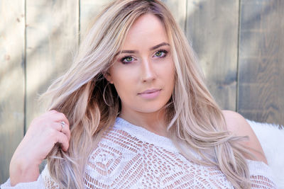 Portrait of beautiful young woman with hand in hair